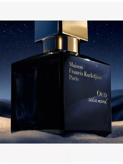 Oud Satin Mood bottle in a night setting
