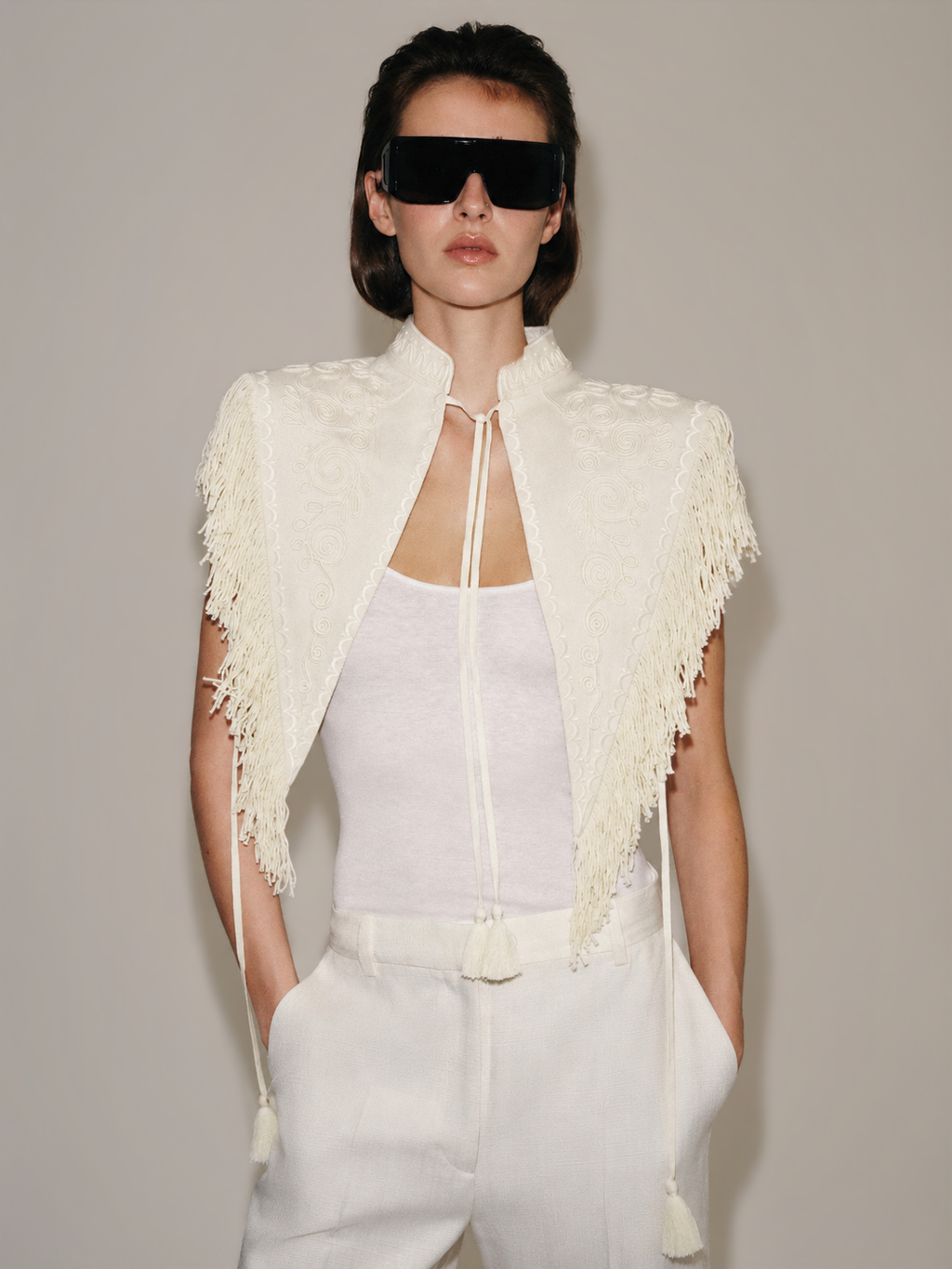 Carlotta Fringe Cape — studio front look over white rib tank and tailored trousers